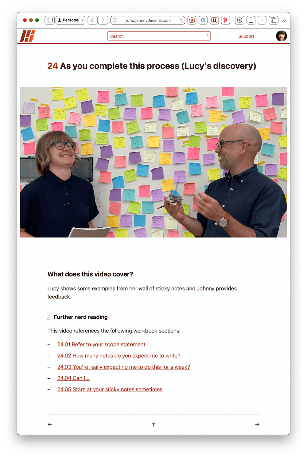 A screenshot of the workshop. Johnny & Lucy are in front of a wall of brightly-coloured Post-it notes.